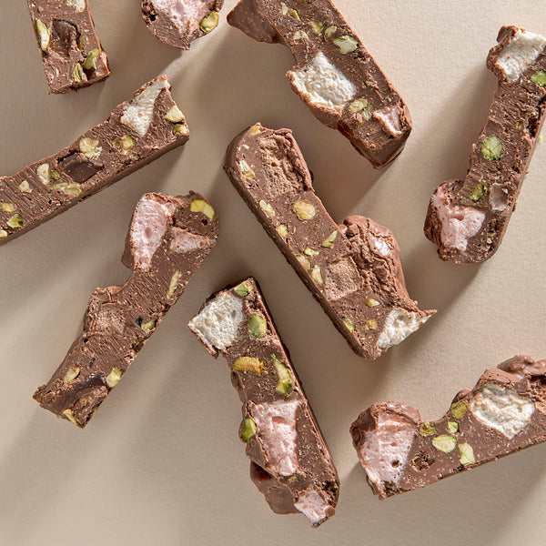Chopped pieces of Milk Chocolate Rocky Road with visible marshmallows, pistachios, and pieces of Turkish delight.
